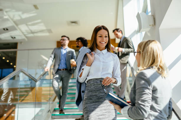 istock Two businesswomen discussing report on stairs 1148990601