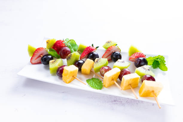 Tasty fruit skewers on the white background, Concept of healthy, fat free eating