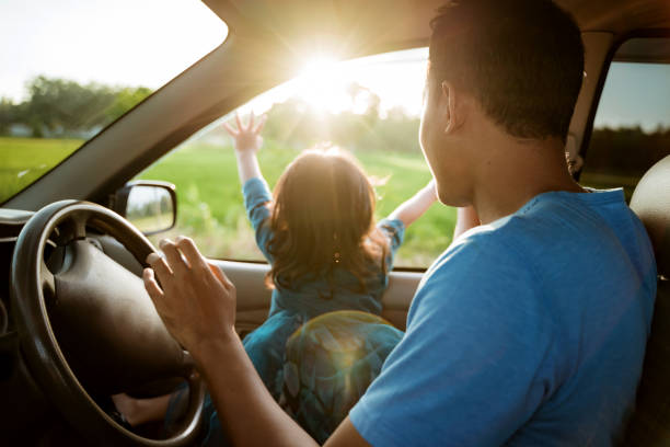 istock dad and daughter enjoy sunset inside car 1148991800