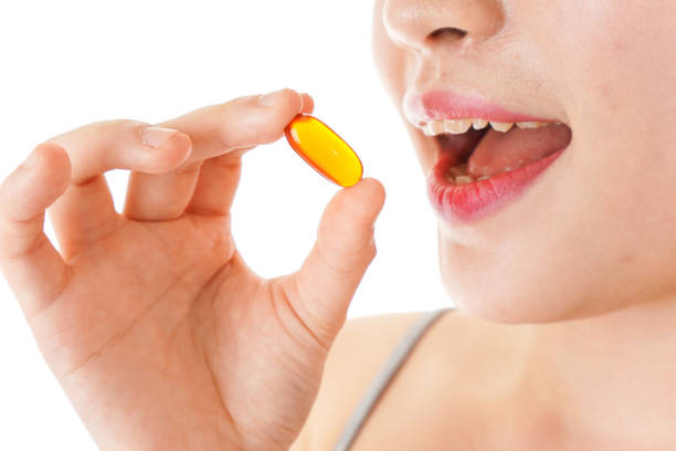 istock Young woman taking medicine, supplements 1148991843