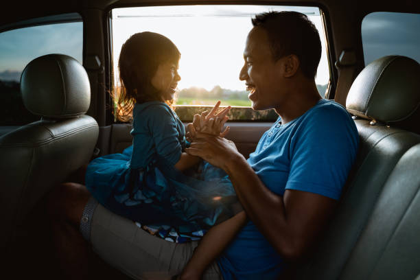 istock asian daughter with father in the car playing 1148991982