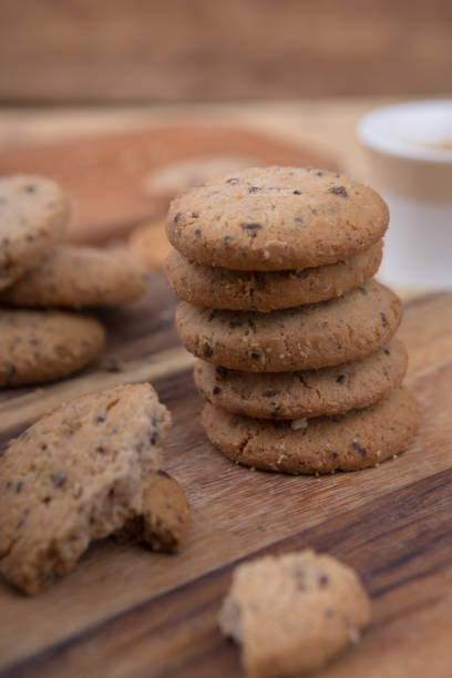 istock Stacked chocolate chip cookie on wooden table 1148992212