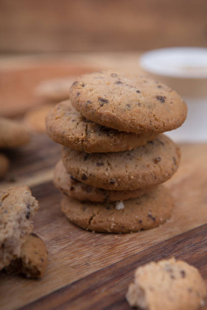 istock Stacked chocolate chip cookie on wooden table 1148992249