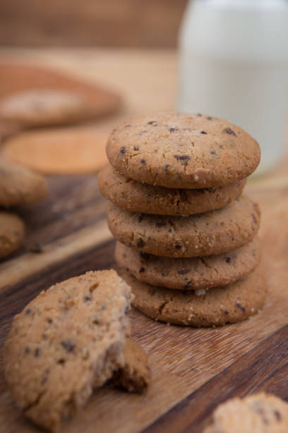 istock Stacked chocolate chip cookie on wooden table 1148992283
