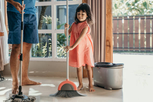 istock father and daughter clean up the house 1148993427