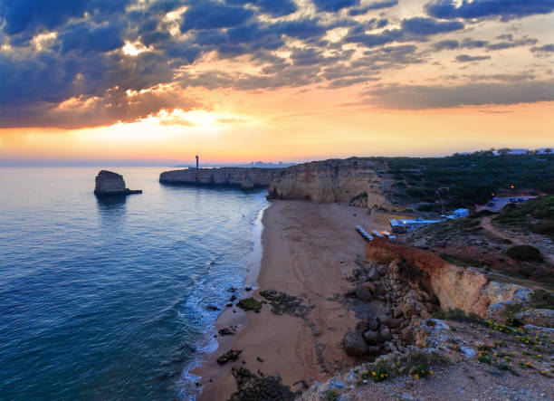 istock Sea coast sunset landscape and lighthouse 1148995529