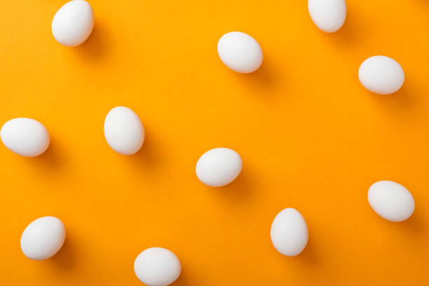 istock top view of whole white fresh chicken eggs on bright orange background 1148997515