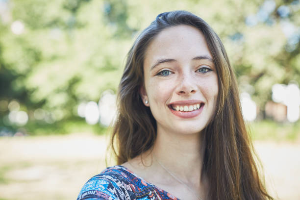 istock Portrait of beautiful young brunette smiling in park setting 1148998828