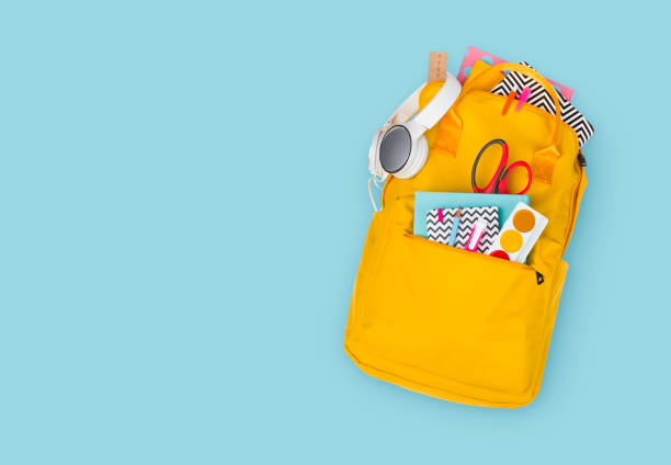 Backpack with school supplies, top view. Back to school concept