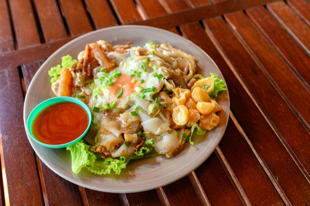 istock Stir-fried rice noodle with chicken, squid, fry egg and lettuce 1149001932