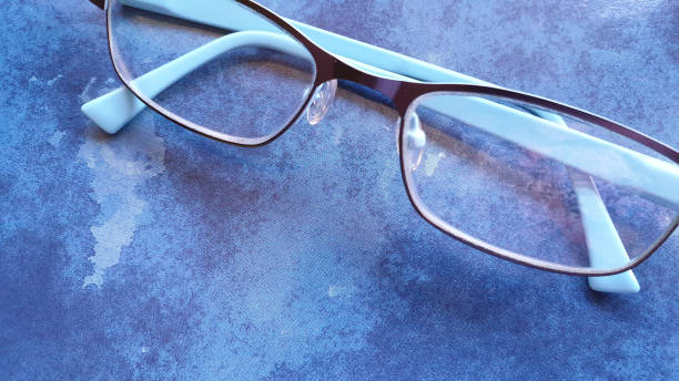 istock Blue reading glasses on blue background with copy space 1149002025