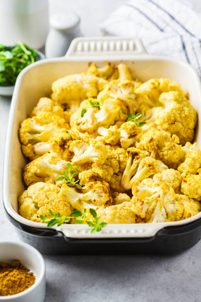 istock Baked cauliflower in oven dish on white concrete background. 1149003365