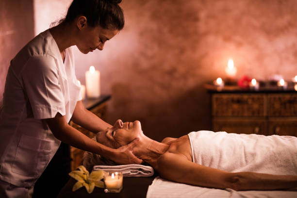 istock Smiling massage therapist massaging senior woman's neck at the spa. 1149011189