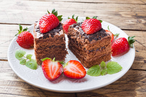 istock Chocolate truffle cake with strawberries and mint. Wooden table. 1149012654