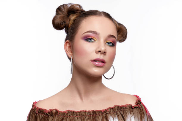 istock Charming model with trendy art makeup on white background 1149012832