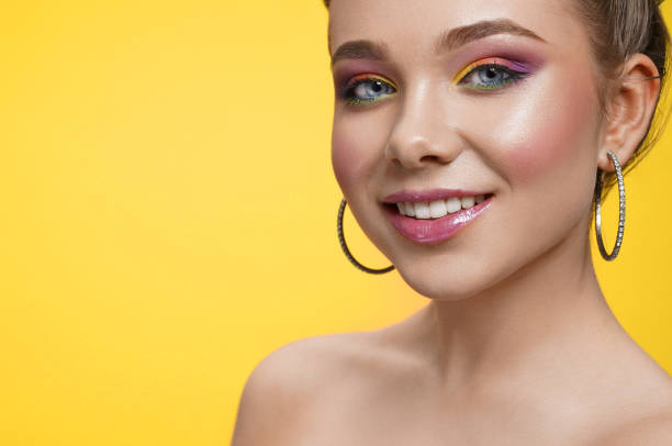istock Happy girl with bright makeup looking at camera and laughing 1149012840