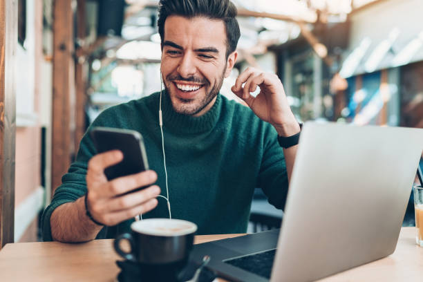 istock Young man watching video on his cell phone 1149012919
