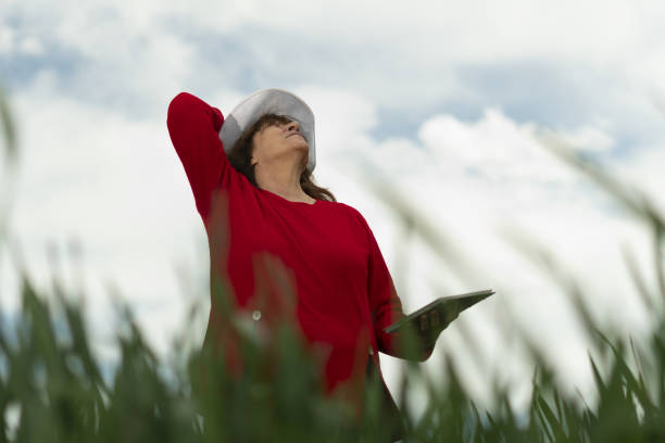istock The Modern Farmer Woman Walking In A Green Wheat Field in Springtime, Using Digital Tablet. Innovation in Agriculture. Woman Leader Working Outdoors. 1149018367