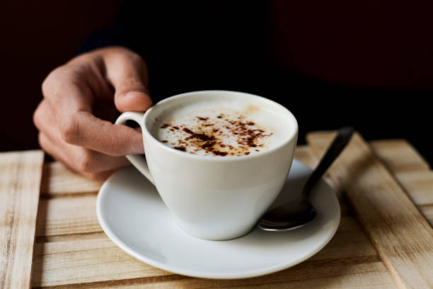 istock young man with a cup of cappuccino 1149023929