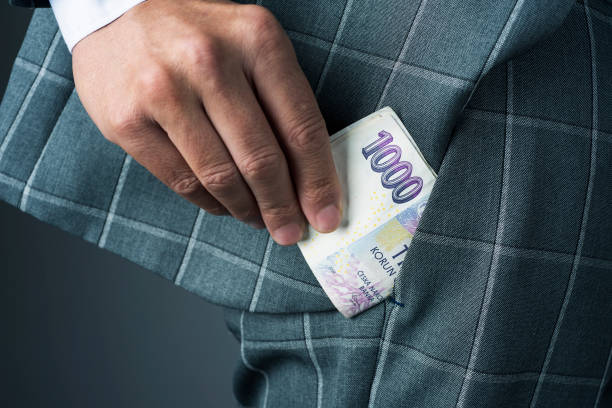 istock businessman with czech korunas banknotes 1149023940
