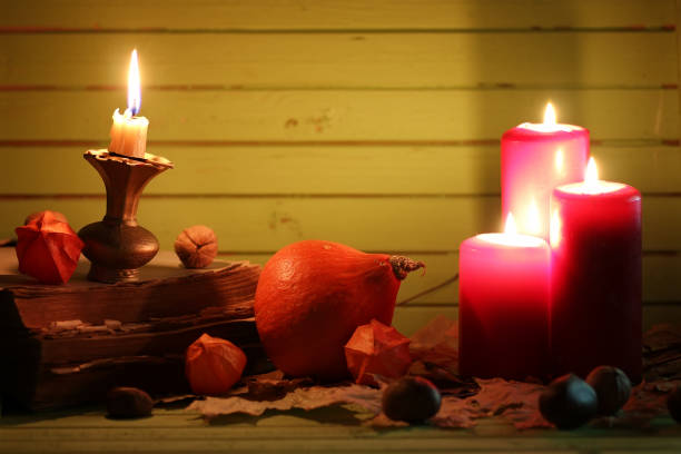 istock old book pumpkin and candle on wooden table 1149024335