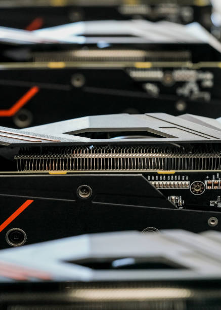 istock Selective focus photo (only metal cooler in focus), row of video graphics cards on computing rig. Abstract cryptocurrency mining background 1149024451