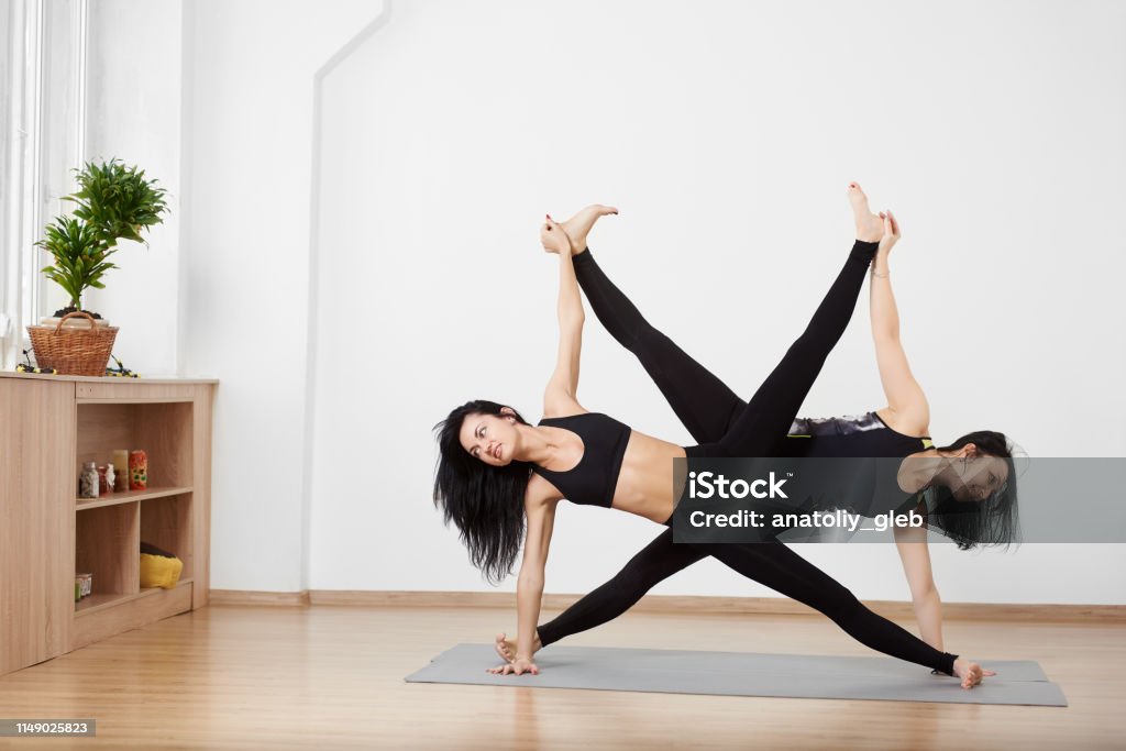Slim Female Exercising Standing Asana Practicing Double Side Plank With  Lifting Leg To Each Other Partner Yoga Concept Stock Photo - Download Image  Now - iStock