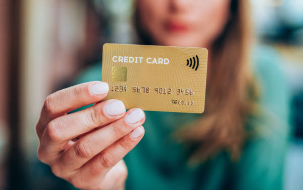 istock Shopper holding a credit card 1149028135