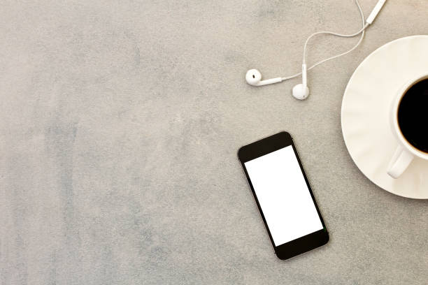 istock Mobile phone, coffee cup and headphone on gray background. 1149028412