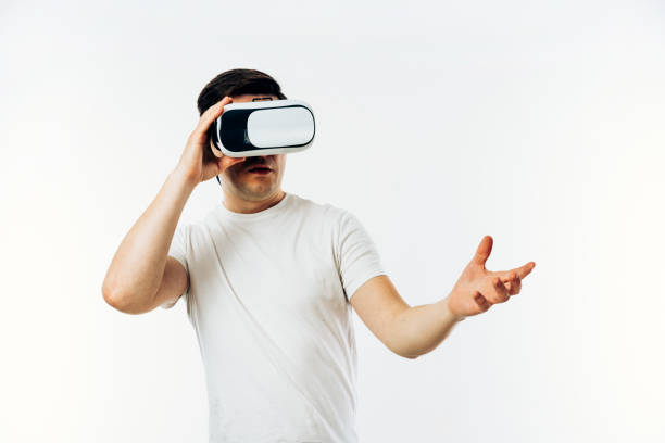 istock Man in white T-shirt wearing virtual reality 3D headset 1149029041