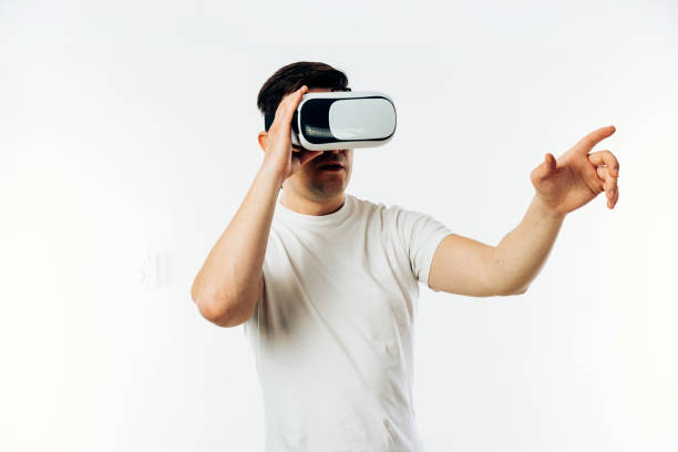 istock Man in white T-shirt wearing virtual reality 3D headset 1149029055