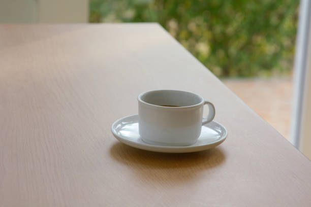 istock White cup of coffee on the table in cafeteria 1149029613