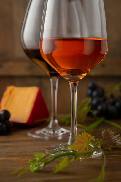 istock Two glasses of wine on rustic background 1149029844