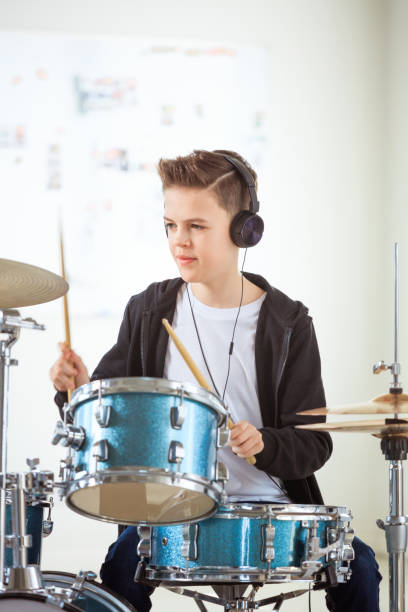 istock Boy playing drums while listening music in class 1149029909