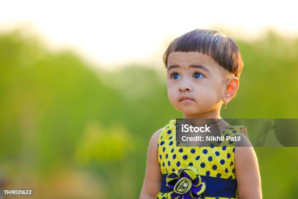 Cute Indian Baby Girl Playing In The Park Stock Photo - Download Image Now  - Animal, Asian and Indian Ethnicities, Beauty - iStock