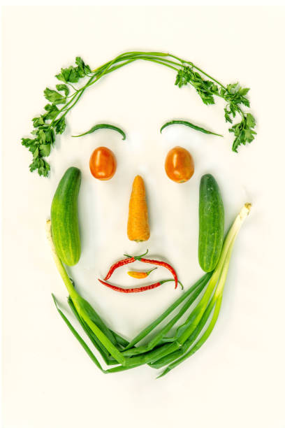 istock Top view of various fresh vegetables face shape isolated on white 1149033000
