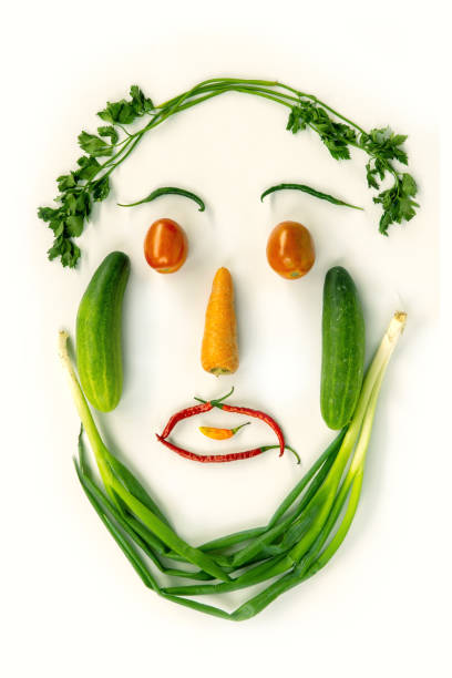 istock Top view of various fresh vegetables face shape isolated on white 1149033147