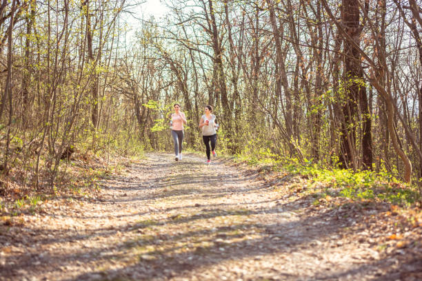 istock Two young women running in a forest. 1149033231