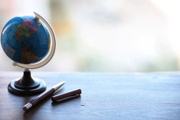 istock A pen on the desk and a small globe 1149035099