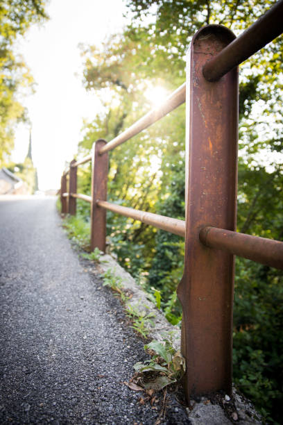 Guard railing with selective focus, asphalted road in Italy