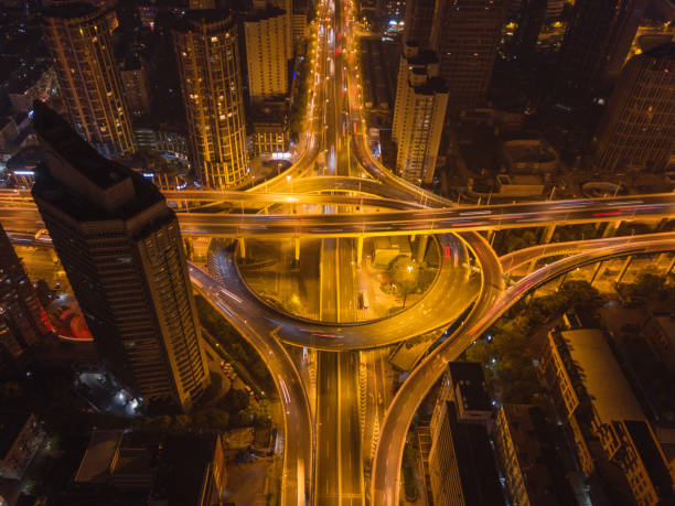 istock Aerial view of highway junctions with roundabout. Bridge roads shape circle in structure of architecture and transportation concept. Top view. Urban city, Shanghai at night, China. 1149036713