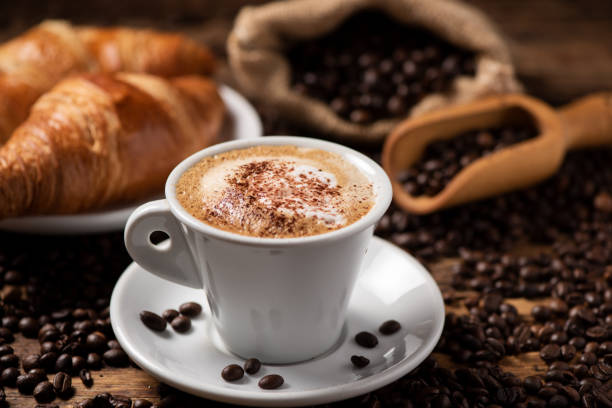istock A cup of cappuccino with coffee bean as background 1149038459
