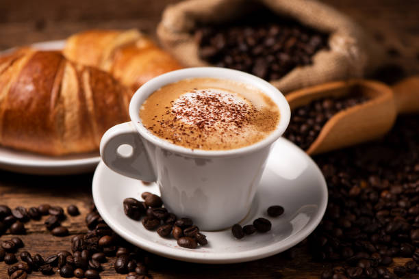 istock A cup of cappuccino with coffee bean as background 1149038628