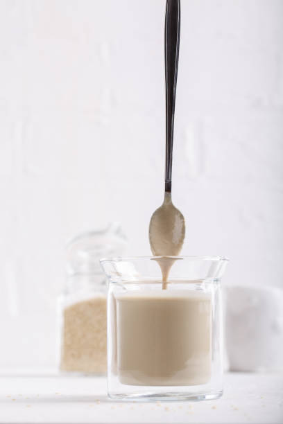 istock Tahini sauce in glass jar on white background. Natural paste made from sesame seeds. 1149039941