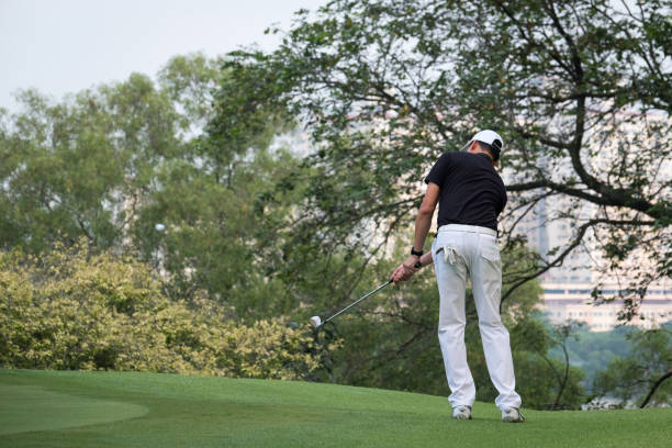 istock Golf player swinging club on field 1149039947