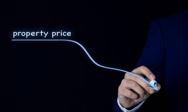 istock businessman draws an arrow falling real estate prices 1149040104