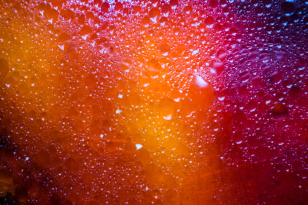 istock blurred colorful light and shadow red orange yellow of oil surface texture 1149042233
