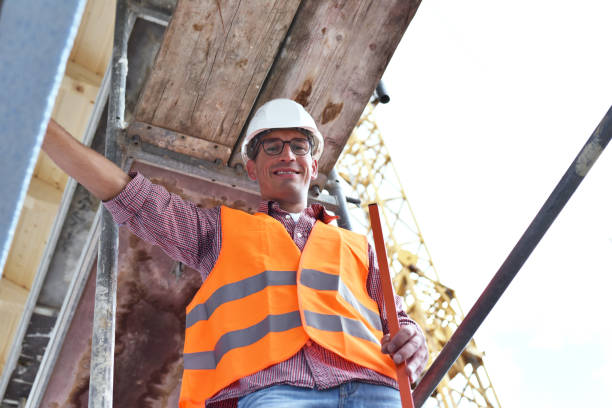 istock portrait smiling construction manager / architect on site during the construction of a house - planning and control on site 1149043619