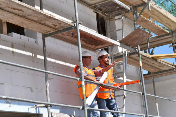istock construction manager and architect on site during the construction of a house - planning and control on site - teamwork 1149043696