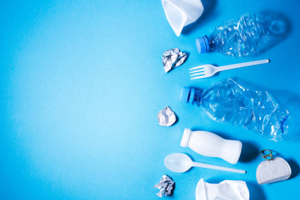 Plastic trash on blue background, Plastic trash on blue background, eco concept image with copy space. disposable stock pictures, royalty-free photos & images